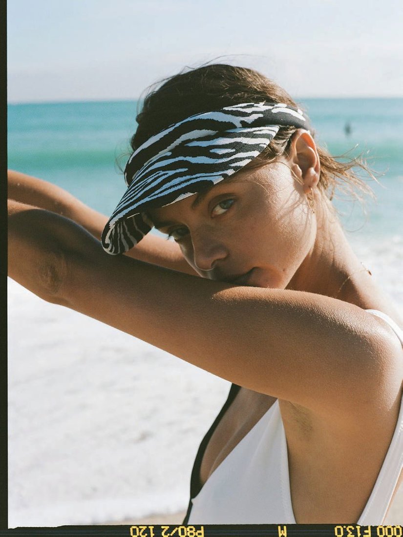 Zebra visor paired with Solid & Striped’s Lucia one-piece bathing suit in Blackout and Marshmallow PRODUCT PHOTOS COURTESY OF LELE SADOUGHI